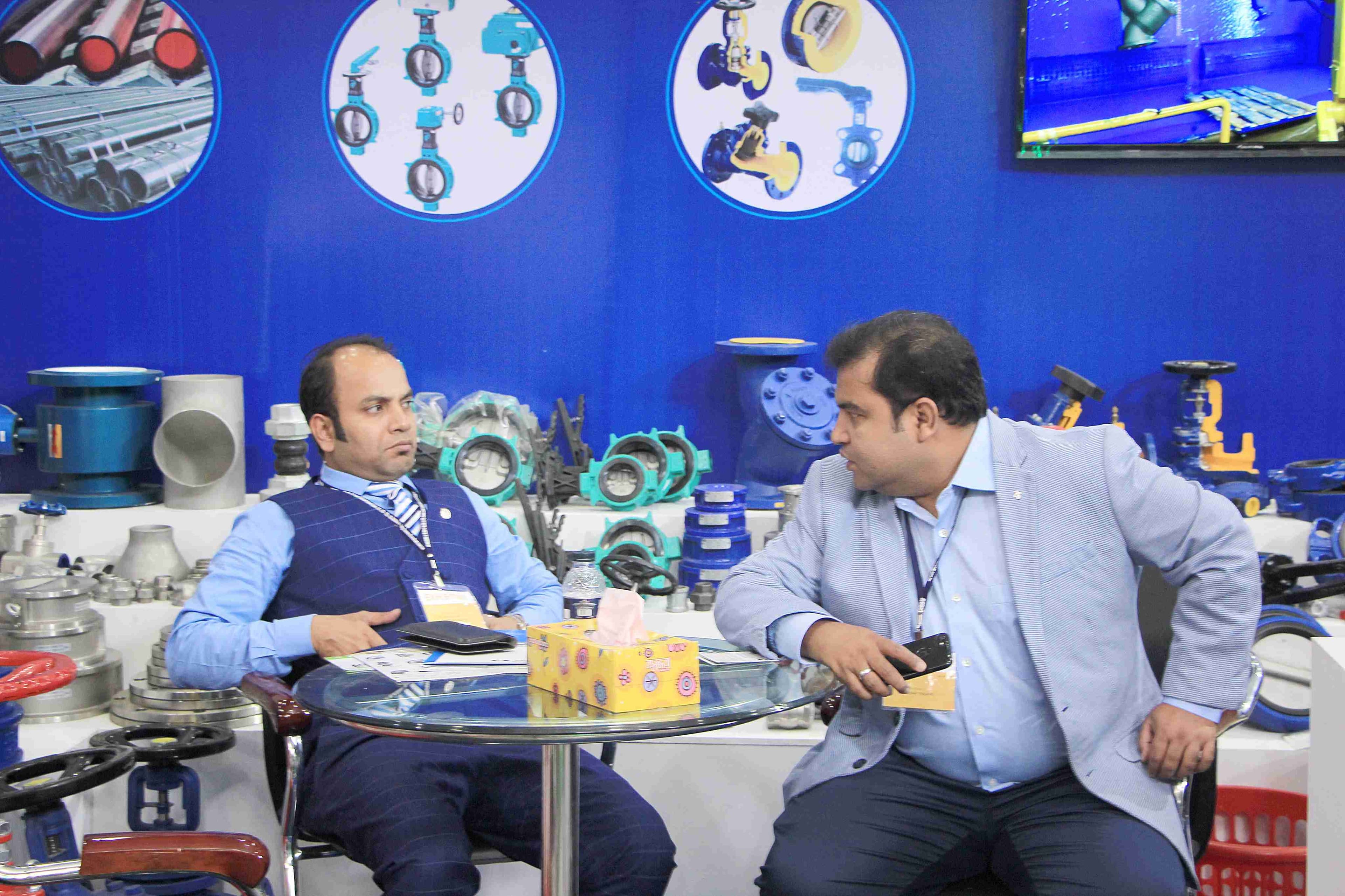 Business discussion at the Asgar Trading booth